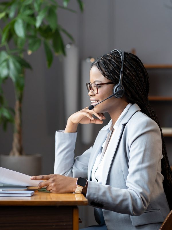 young-positive-african-woman-remote-recruiter-using-wireless-headset-to-communicate-with-candidates.jpg